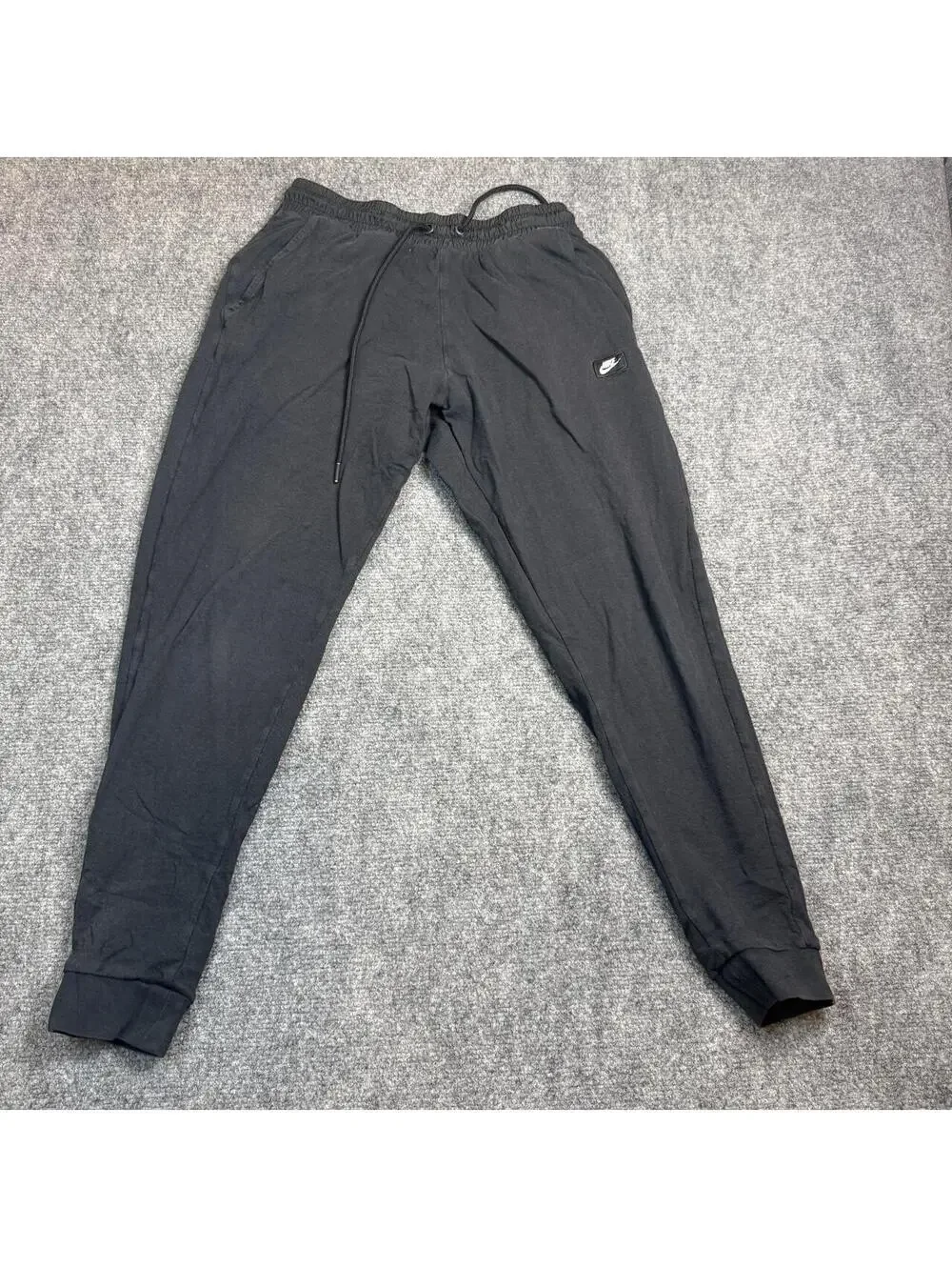 Nike black joggers with drawstring waist and tapered fit, size S